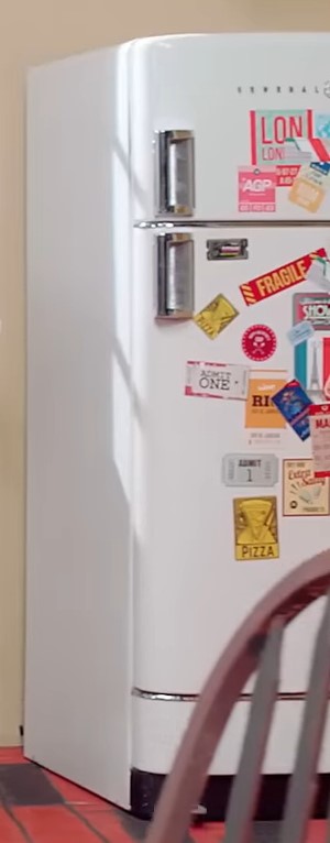A fridge decorated with various stickers.